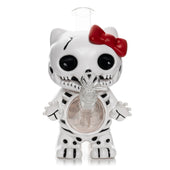 A Hello Kitty skeleton glass water pipe featuring a white skull design with black details, a red bow, and a clear glass bowl.