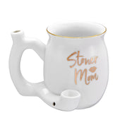White coffee mug that is also a pipe.  It has gold writing on it that says stoner mom, and a lipstick mark.  Gold trim on the rim as well.